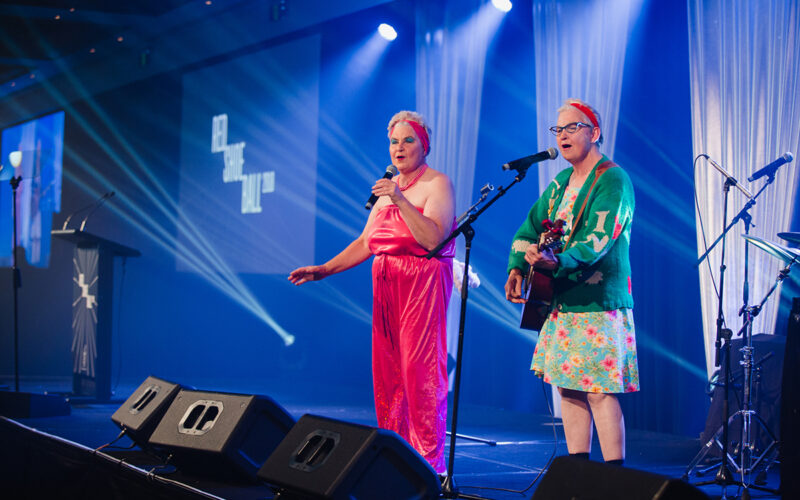 The Topp Twins as Camp Mother and Camp Leader performing at the 2018 Red Shoe Ball at the Langham Hotel in Auckland, New Zealand. This annual charity event was photographed by Auckland event photographer Mala Photography
