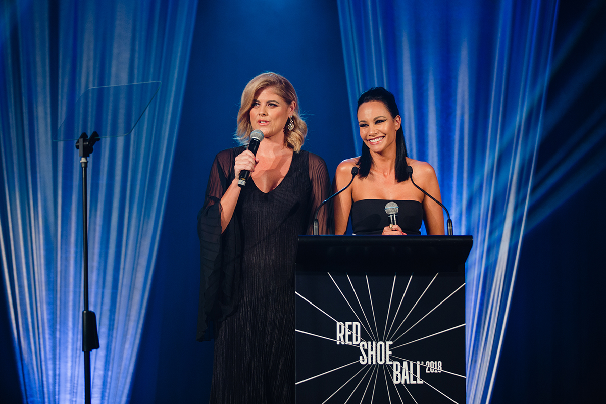 Jo Holley and Shavaughn Ruakere hosting the 2018 Red Shoe Ball, the annual fundraising event for Ronald McDonald House Charities. Photography by Mala Photography, an Auckland based event photographer.