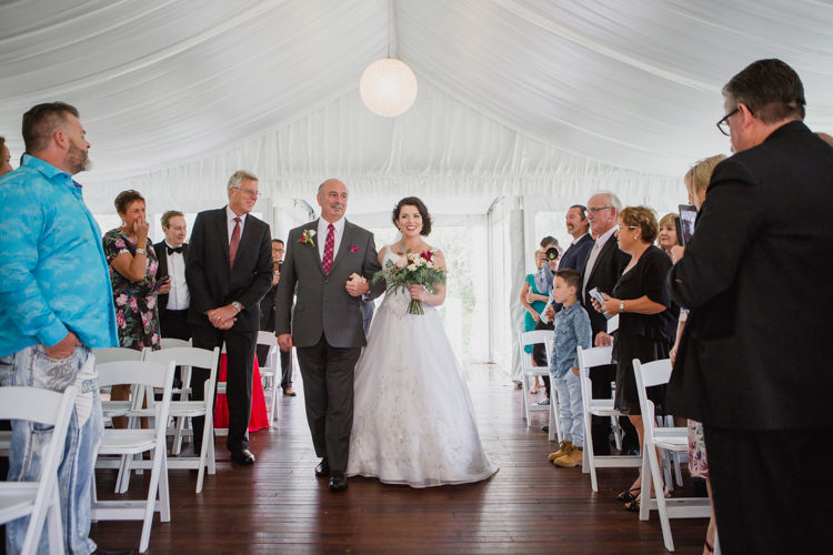 A wedding photo taken during a wedding ceremony at the Bracu Pavilion at the Simunovich Olive Estate in Rama Rama, near Auckland. This wedding photo was taken mb a wedding photographer in Auckland, named Mala Photography.