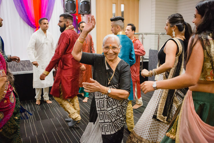A photo of traditional Indian dancing at an Indian wedding. Photo taken by Mala Photography.