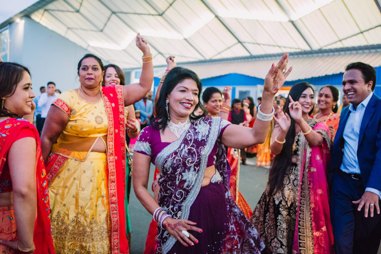 A photo of traditional Indian dancing at an Indian wedding. Photo taken by Mala Photography.