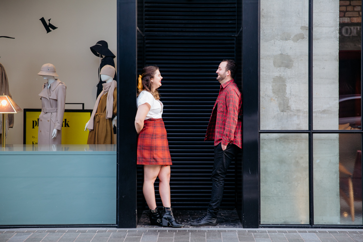 A photo from an inner city Auckland engagement shoot of a couple standing in a doorway. This photo was taken by Mala Photography. Mala is an Auckland based engagement and wedding photographer with a contemporary and creative style.